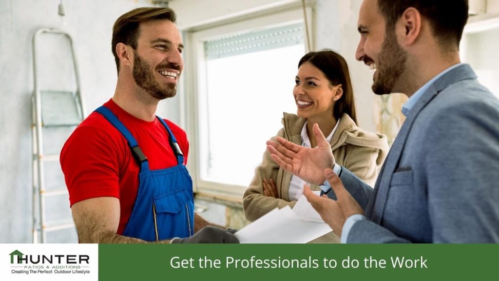 Get the Professionals to do the Work Smiling contractor discussing home renovation plans