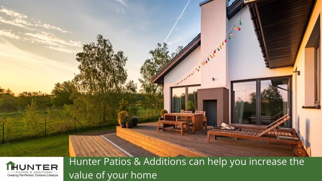 Hunter Patios & Additions can help you increase the value of your home Modern patio design with outdoor seating and decorations.