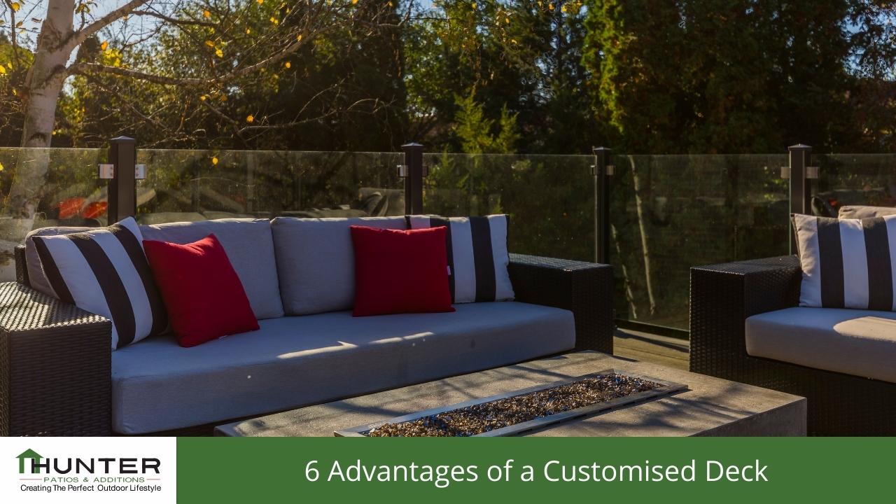 Outdoor patio with sofas and glass railing.