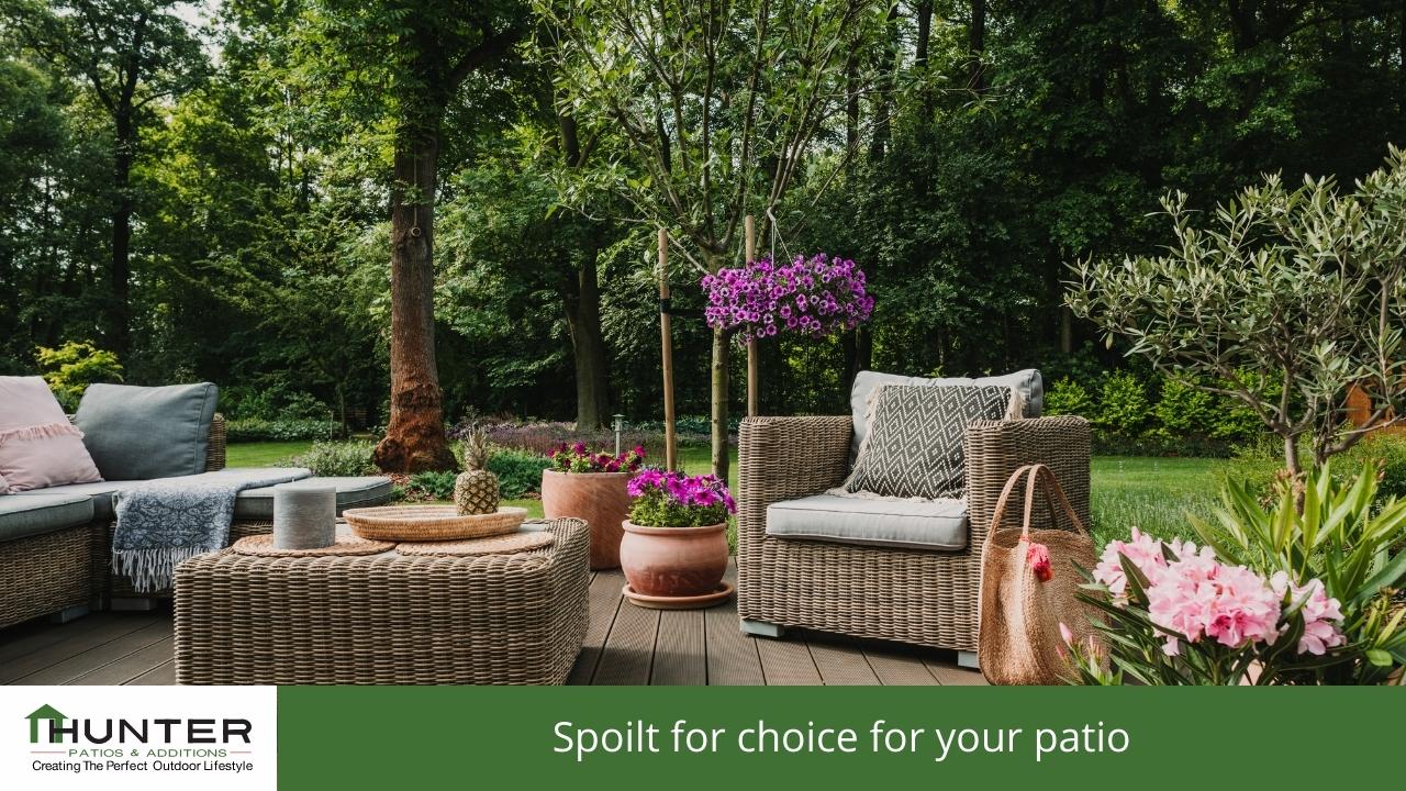 Cozy outdoor patio with wicker furniture and plants.