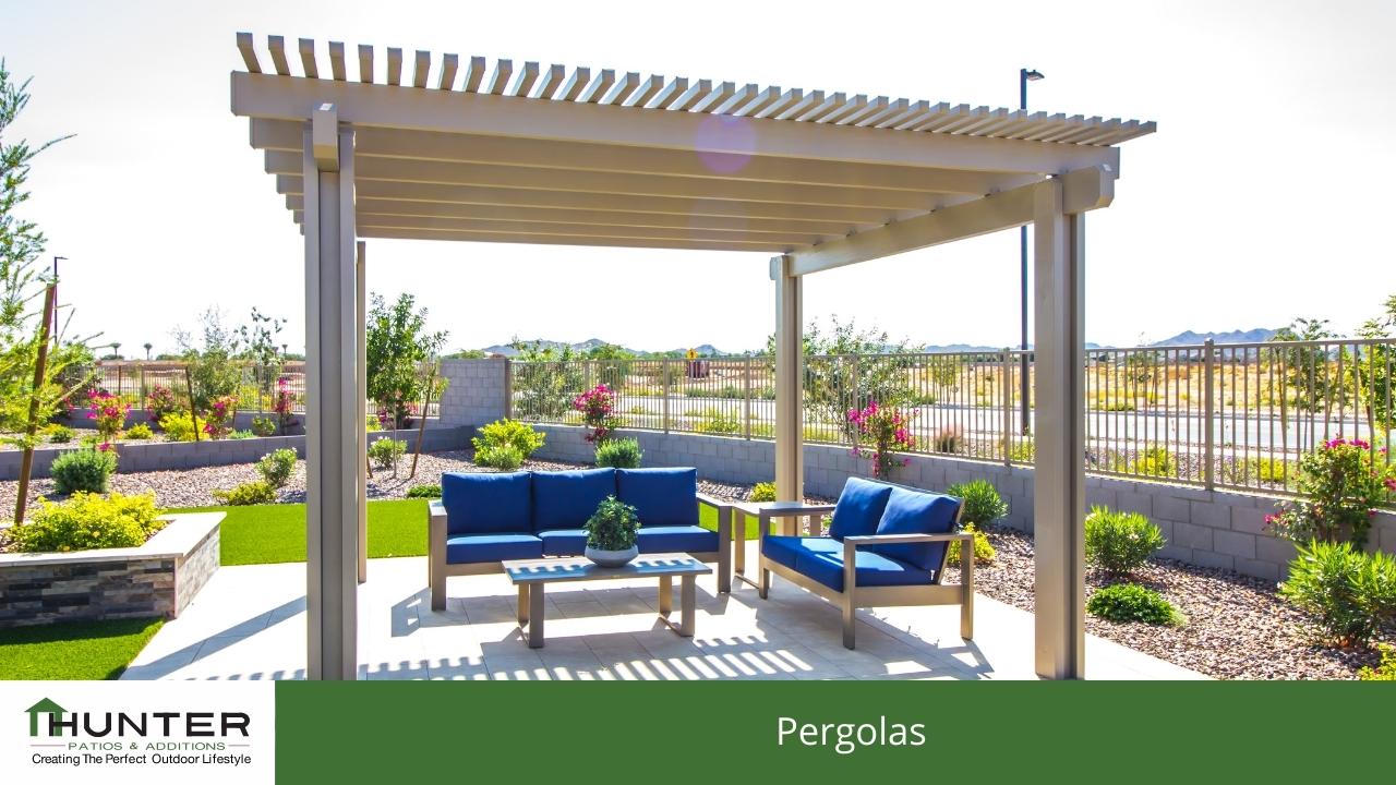 Outdoor pergola with seating and garden view.