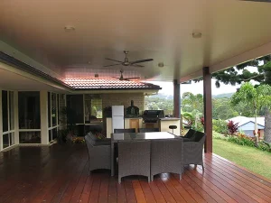 Outdoor patio with wicker furniture and barbecue grill.