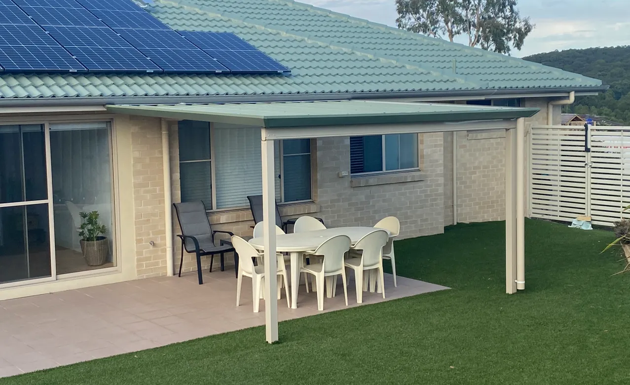 Covered patio with table, chairs, and solar roof.