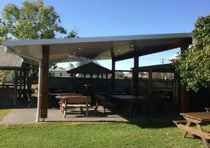Outdoor covered patio with wooden picnic tables