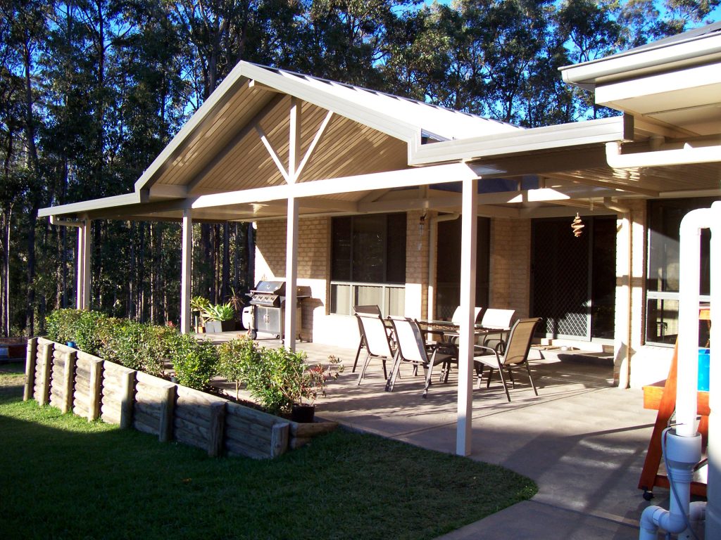 Backyard patio with table and grill