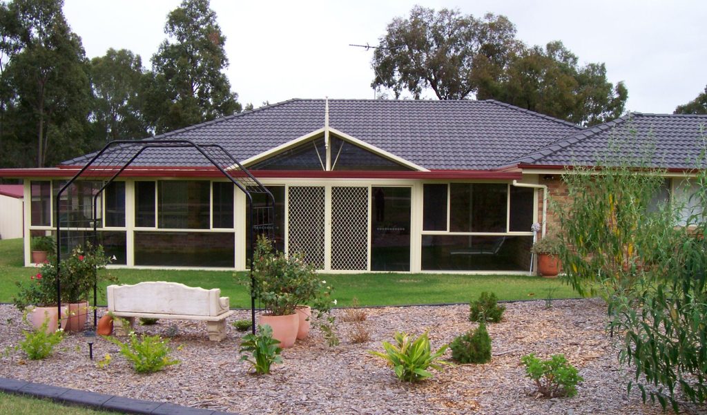 Cozy suburban house with garden bench.