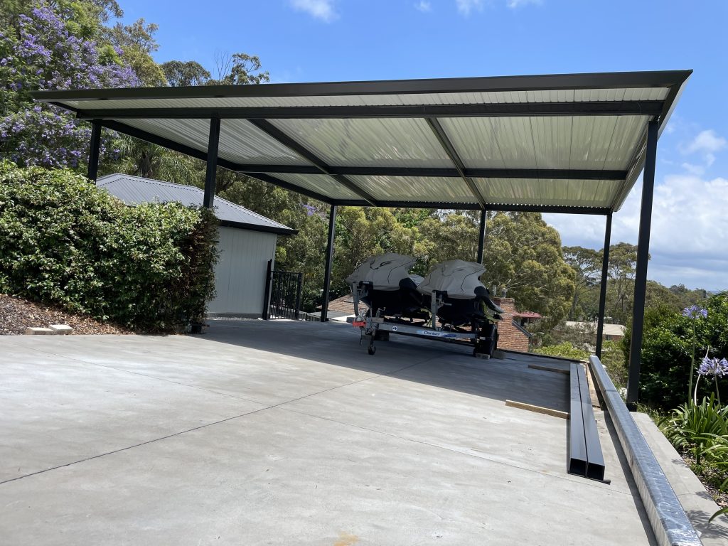 Carport with two jet skis in driveway