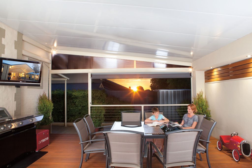 Outdoor patio with sunset view and people seated.