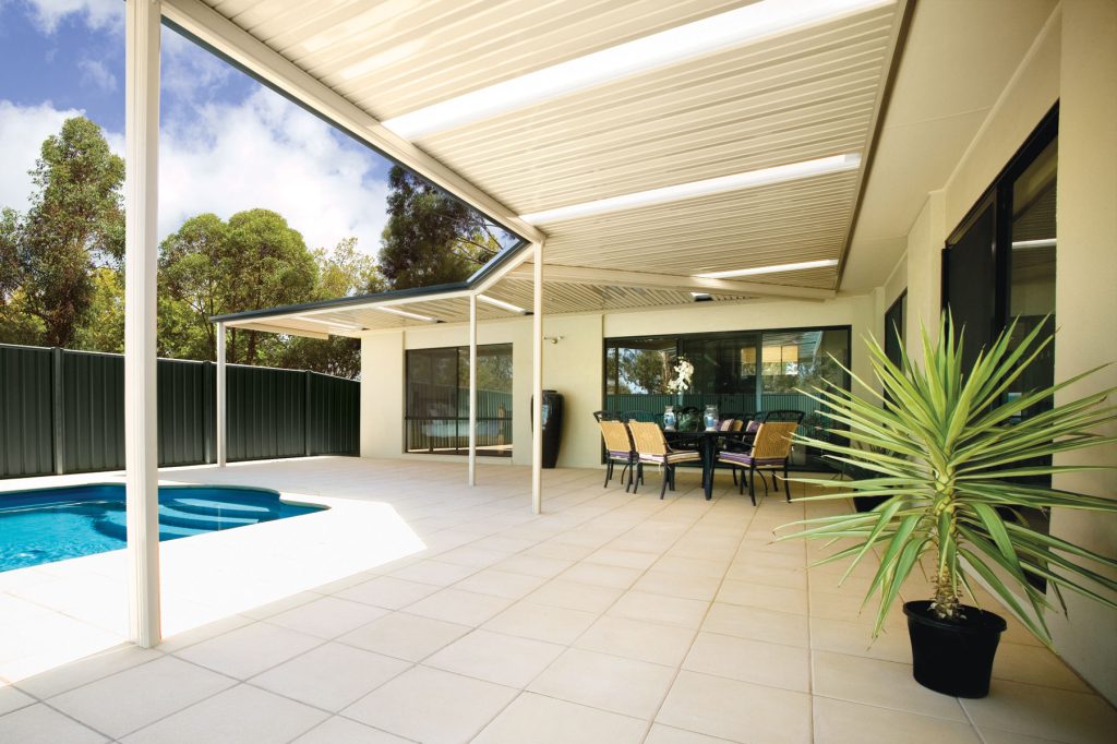 Modern patio with pool and outdoor dining area.