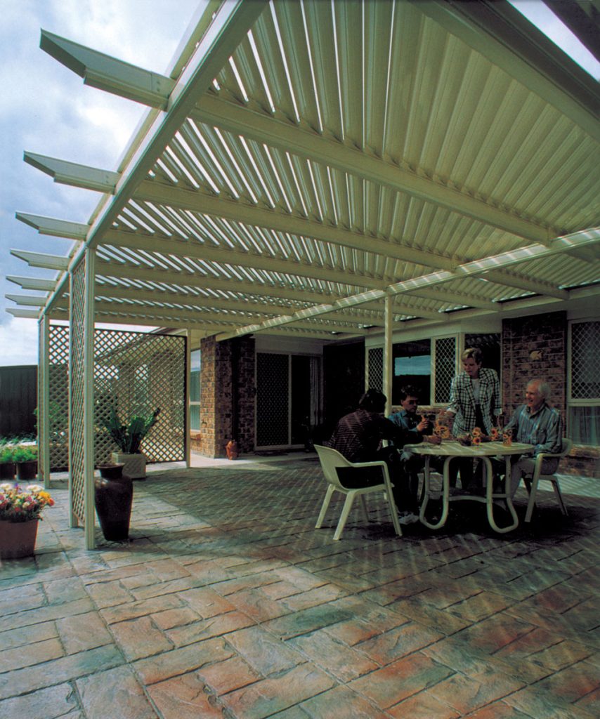 Group enjoying outdoor patio under pergola.