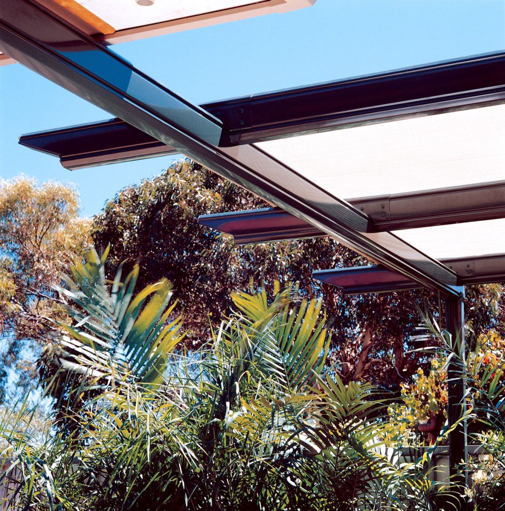 Modern pergola with plants and blue sky background.