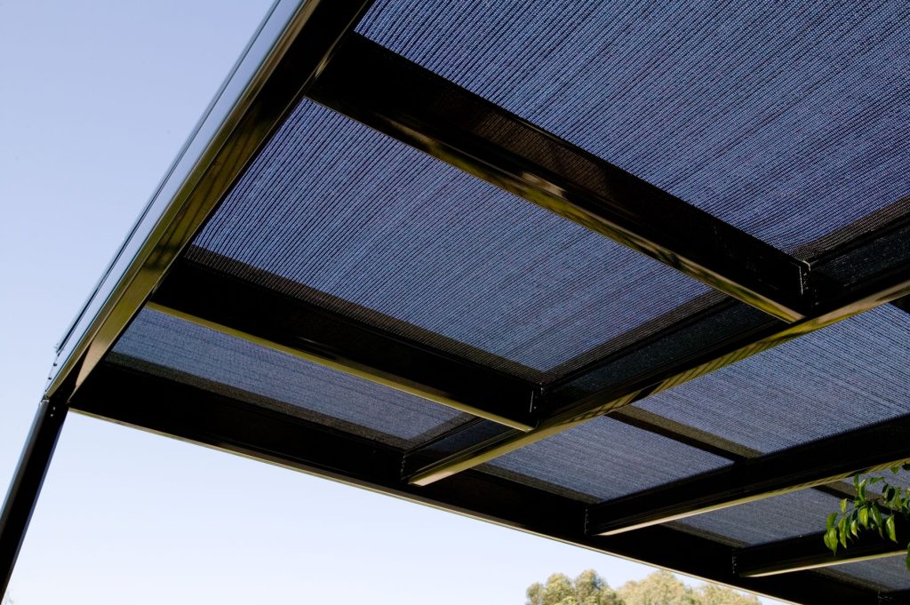 Modern metal pergola with mesh shade panels.