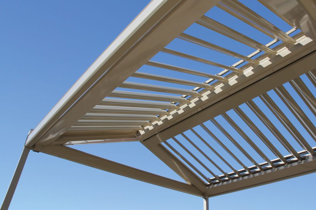 Metal pergola structure against clear blue sky
