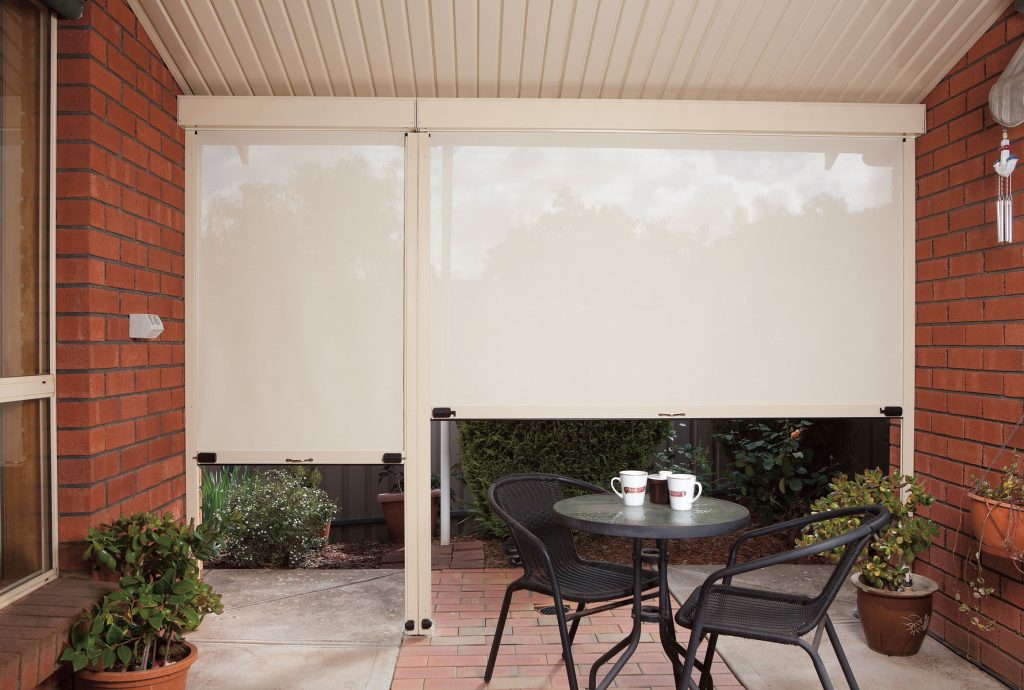 Patio with outdoor blinds and seating area.